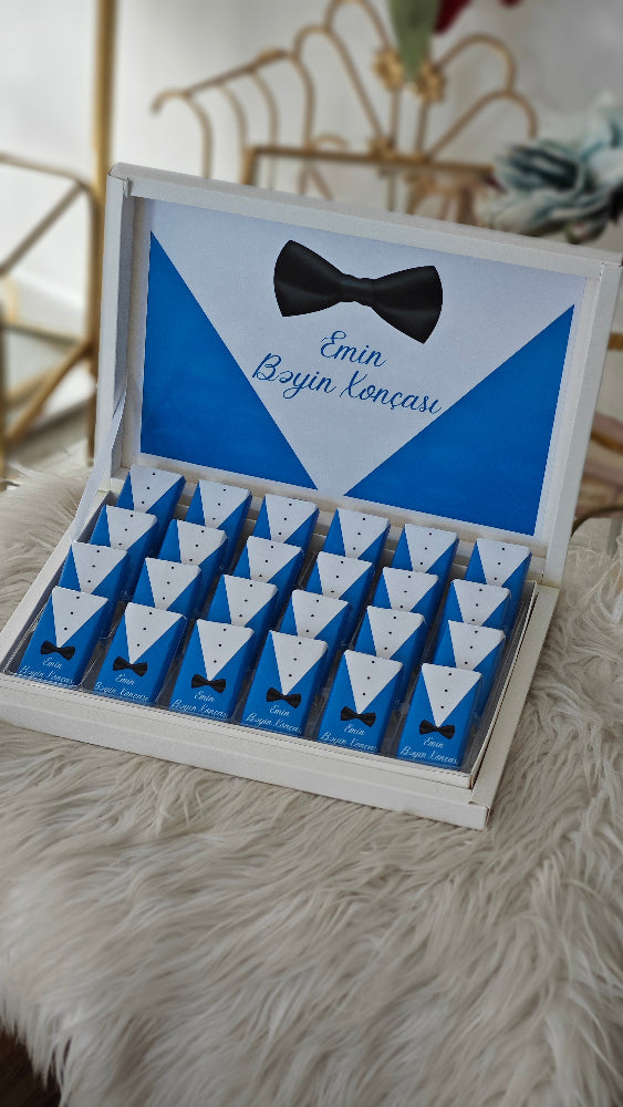 Set of small boxes with bow ties in a decorative box on a fluffy surface