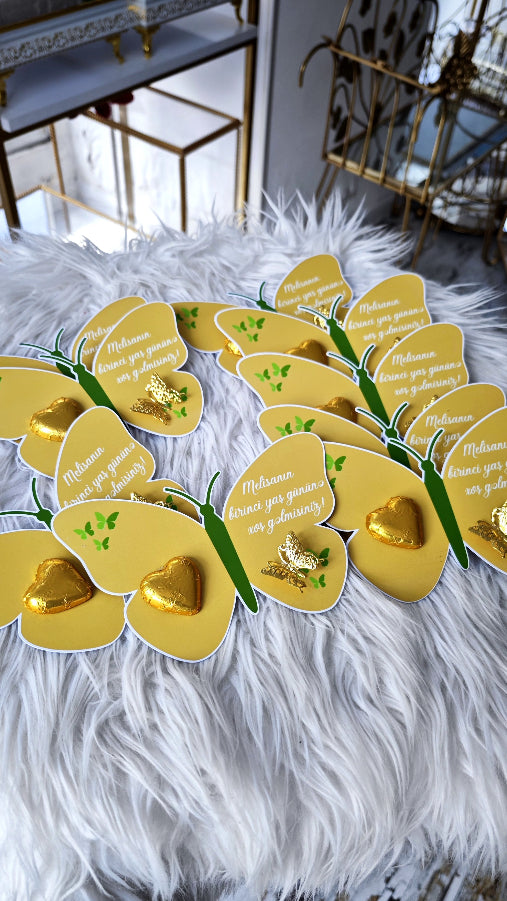 Decorative wreath with gold and green elements on a fluffy white surface.