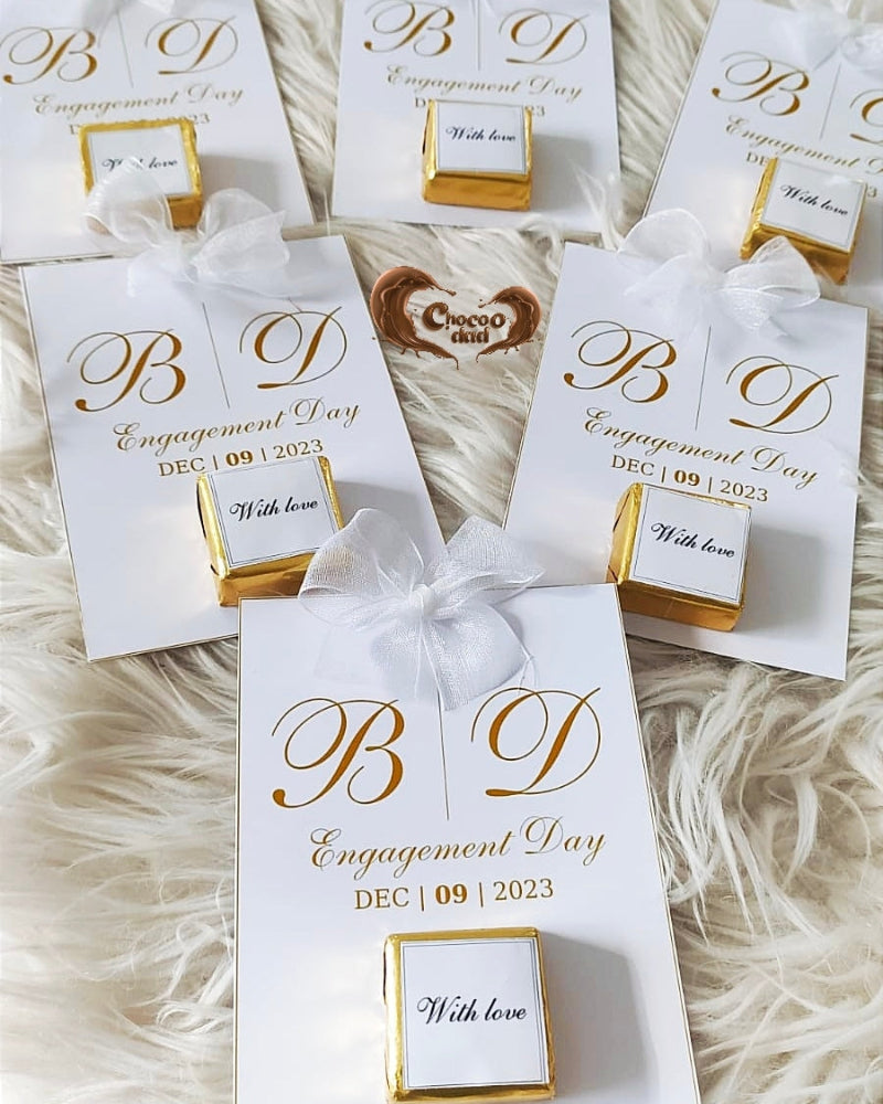 Engagement-themed gift boxes with personalized text on a soft, neutral background