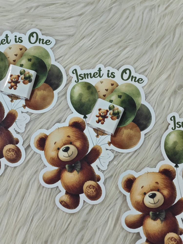 Stickers with teddy bear and balloons design on a wooden surface