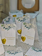 Calendar with floral design and gold heart on a textured surface