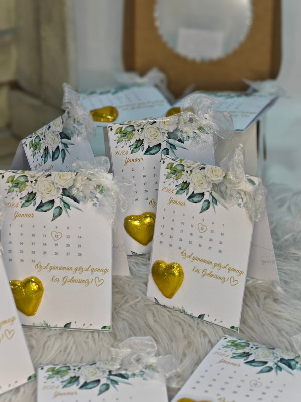 Calendar with floral design and gold heart on a textured surface
