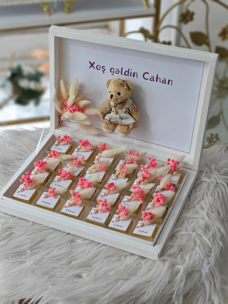 Wooden box with teddy bear and personalized message on a soft surface