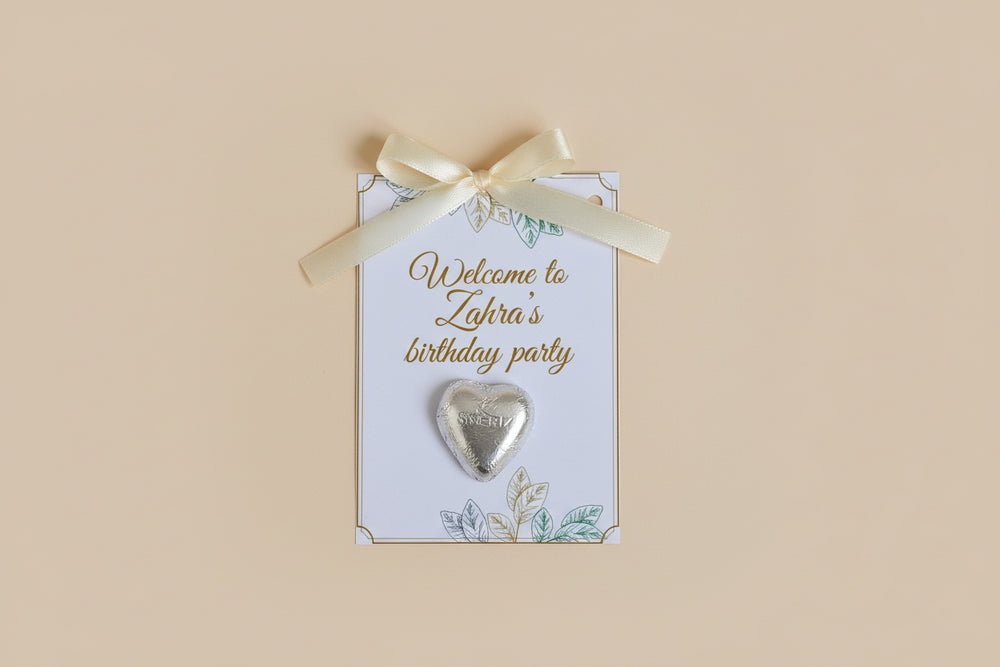 Decorative birthday party invitations with heart-shaped decorations and flowers on a textured surface.