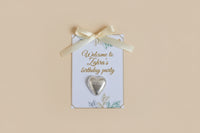 Decorative birthday party invitations with heart-shaped decorations and flowers on a textured surface.