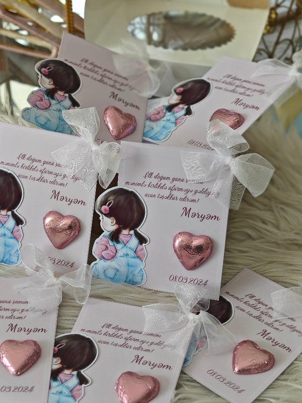 Heart-shaped chocolate candies with decorative packaging featuring illustrations and text.