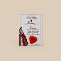 Henna party invitations with red ribbons and heart designs on a textured surface.