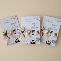 Collection of wedding invitations with cartoon characters and decorative elements on a table.