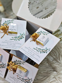 Mugan soap bars with decorative packaging on a textured surface
