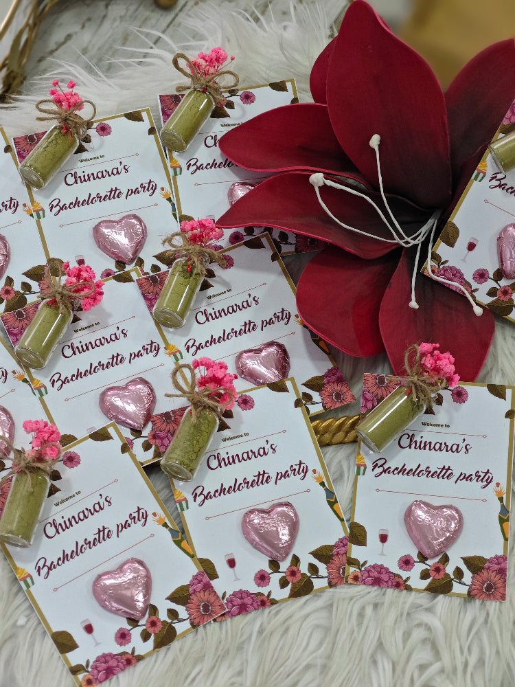 Chinara's Bachelorette party invitations with floral and heart designs on a textured surface.