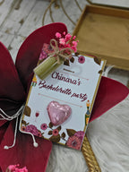 Invitation card for a bachelorette party with decorative elements on a wooden surface.