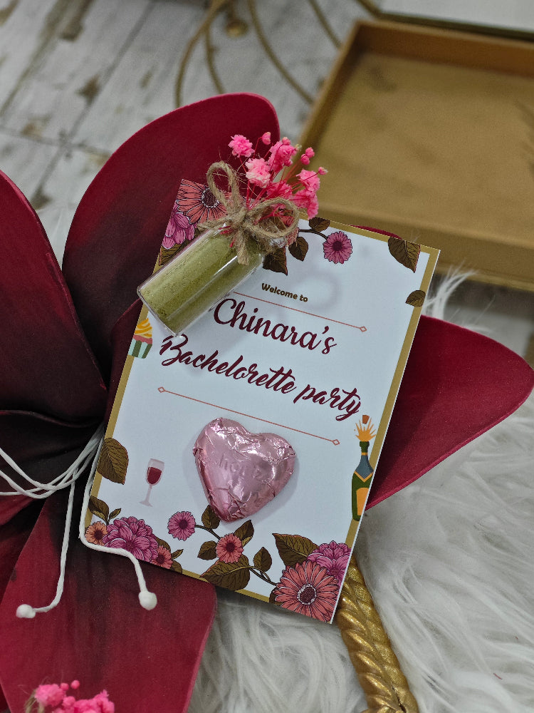 Invitation card for a bachelorette party with decorative elements on a wooden surface.