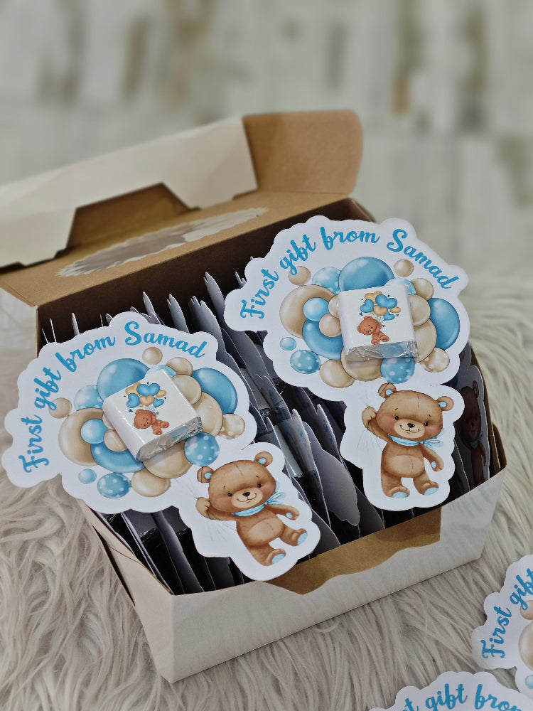 Stickers with teddy bear design and text 'First gift from Samad' in a box.