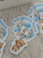 Stickers with teddy bears and balloons on a textured surface