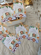 Children's birthday party invitations with lion graphics on a textured surface.