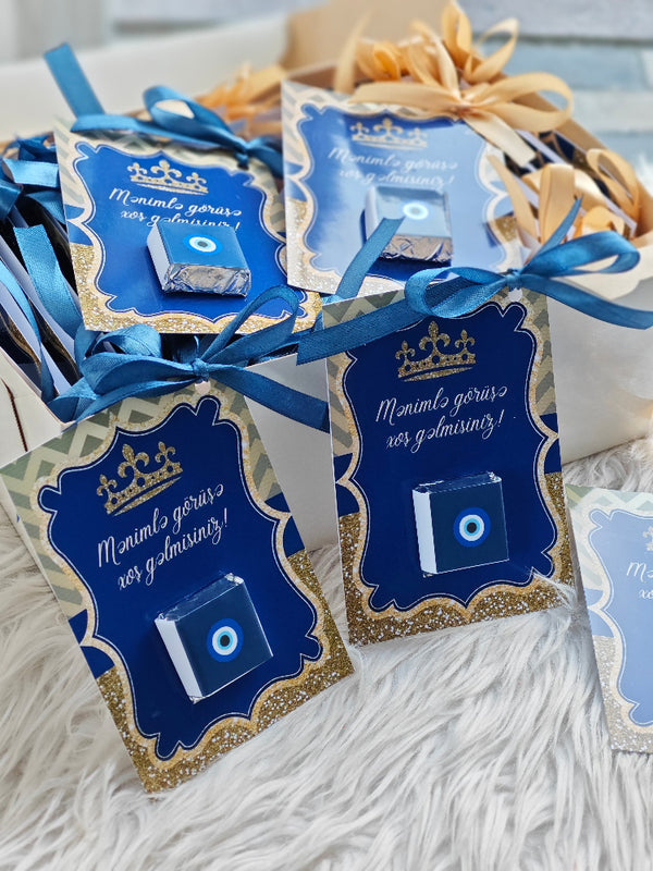 Decorative packages with blue and gold designs on a textured surface