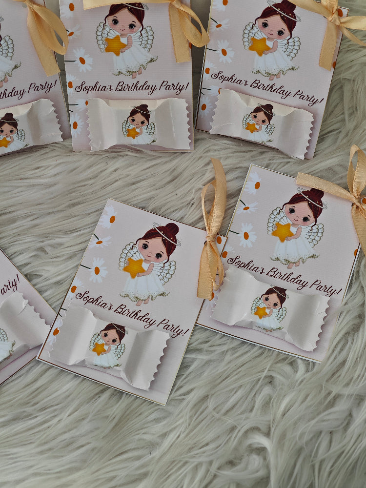 Personalized birthday party favor bags with cartoon character on a textured surface