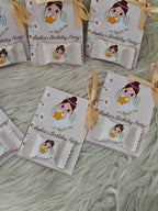 Personalized birthday party favor bags with cartoon character on a textured surface