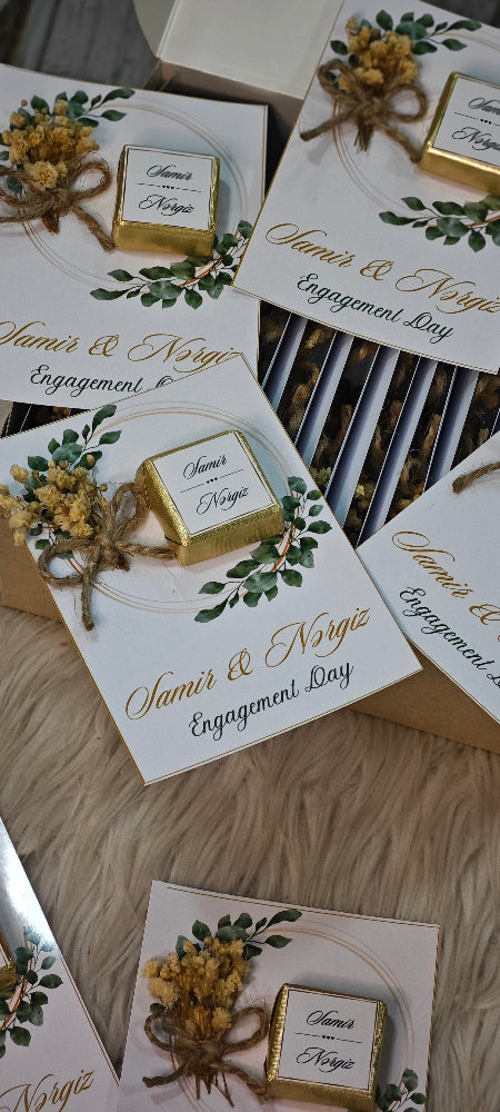 Engagement gift boxes with decorative elements on a wooden surface