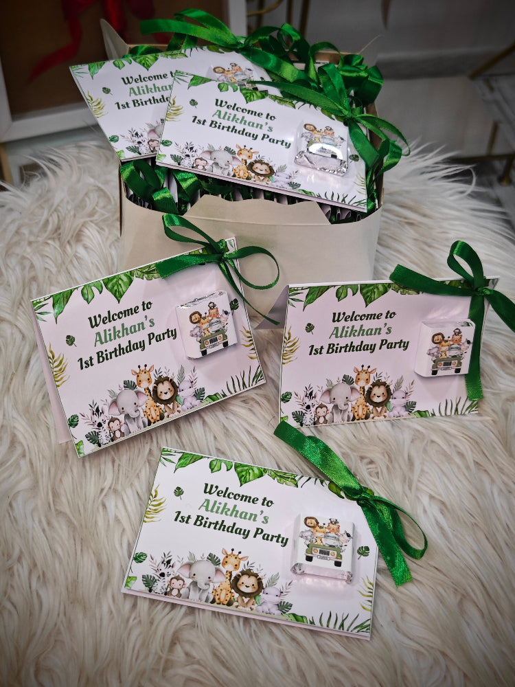 Set of birthday party invitations with green ribbons on a fluffy white surface