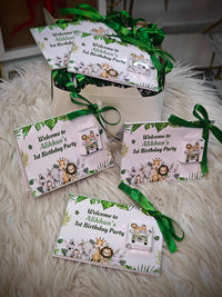 Set of birthday party invitations with green ribbons on a fluffy white surface
