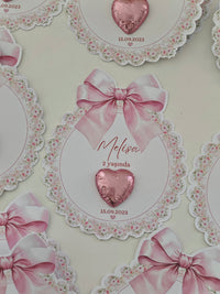 Decorative card with pink heart and bow design, featuring text and a floral border.