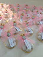 Decorative items with pink ribbons and decorative elements on a white surface