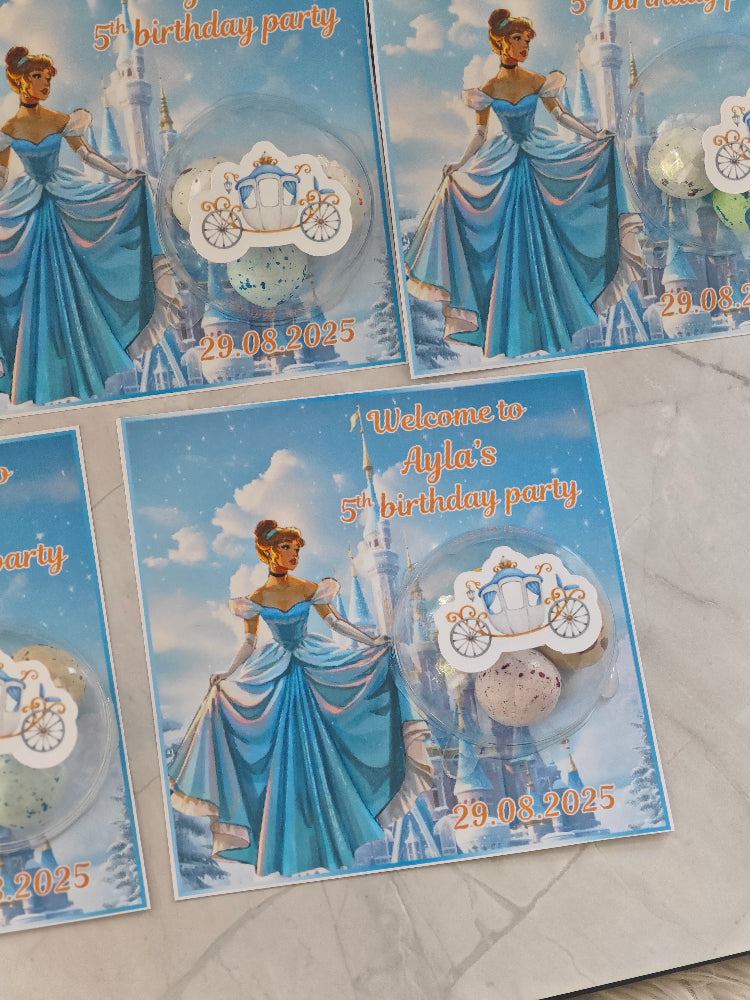 Cinderella-themed birthday party invitations on a marble surface