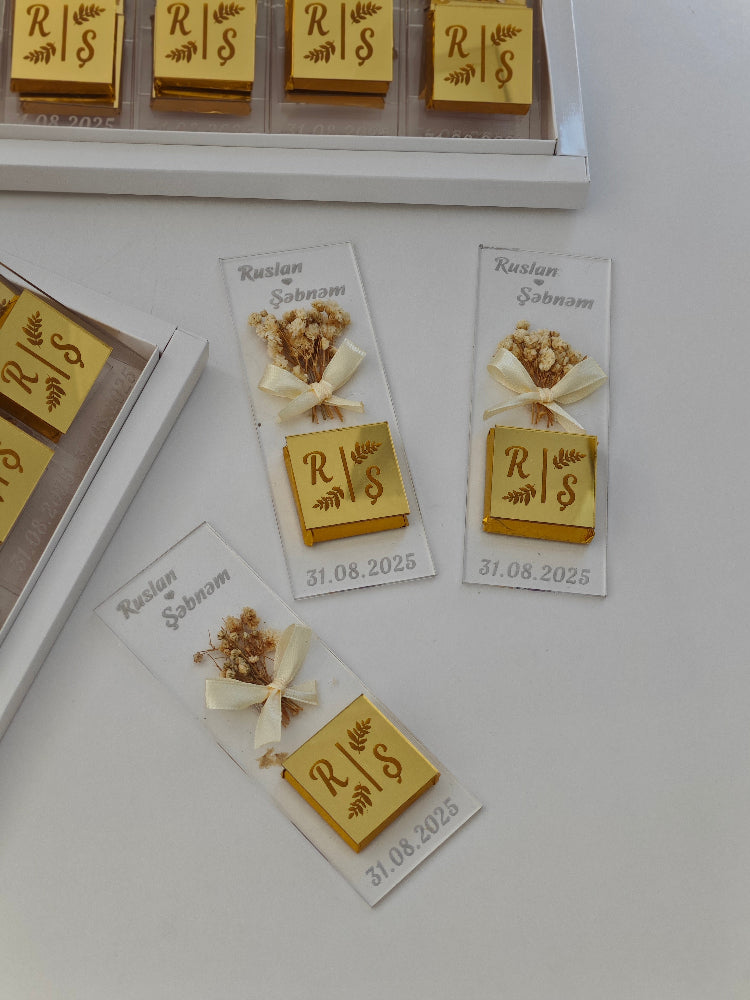 Gold stamps with initials 'RS' on small cards with decorative elements.