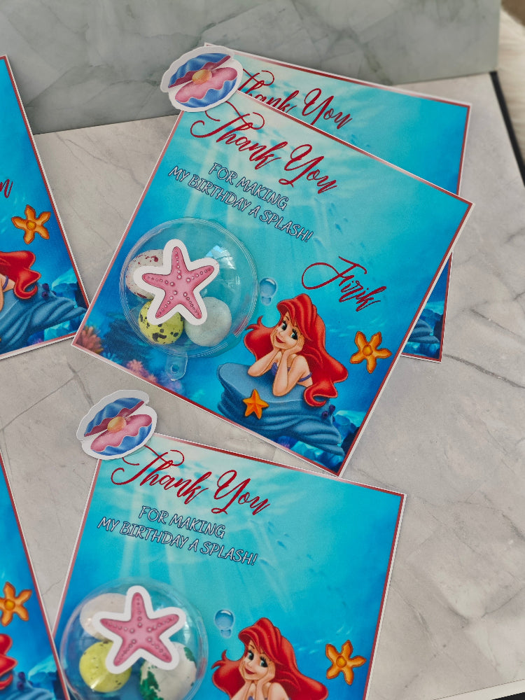 Underwater-themed thank you cards with a mermaid design on a marble surface.