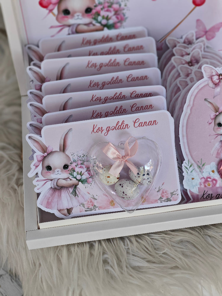 Set of cards with a cute bunny design and decorative elements on a fluffy surface.