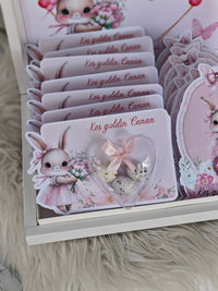 Set of cards with a cute bunny design and decorative elements on a fluffy surface.