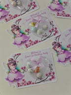 Decorative birthday party cards with fairy illustrations and decorative elements on a light background.