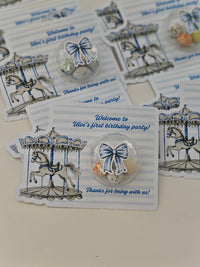 Collection of birthday party favor cards with carousel design and decorative bows.