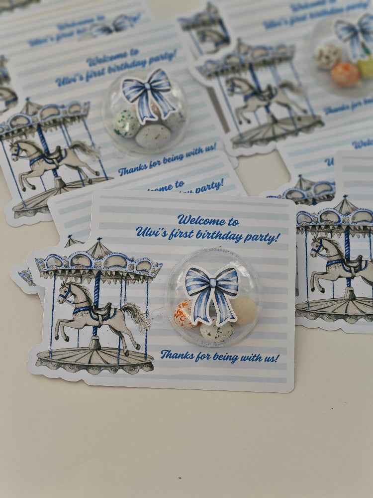 Collection of birthday party favor cards with carousel design and decorative bows.