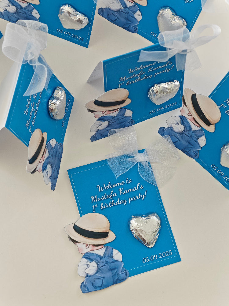 Silver heart-shaped jewelry on blue cards with decorative elements on a white background