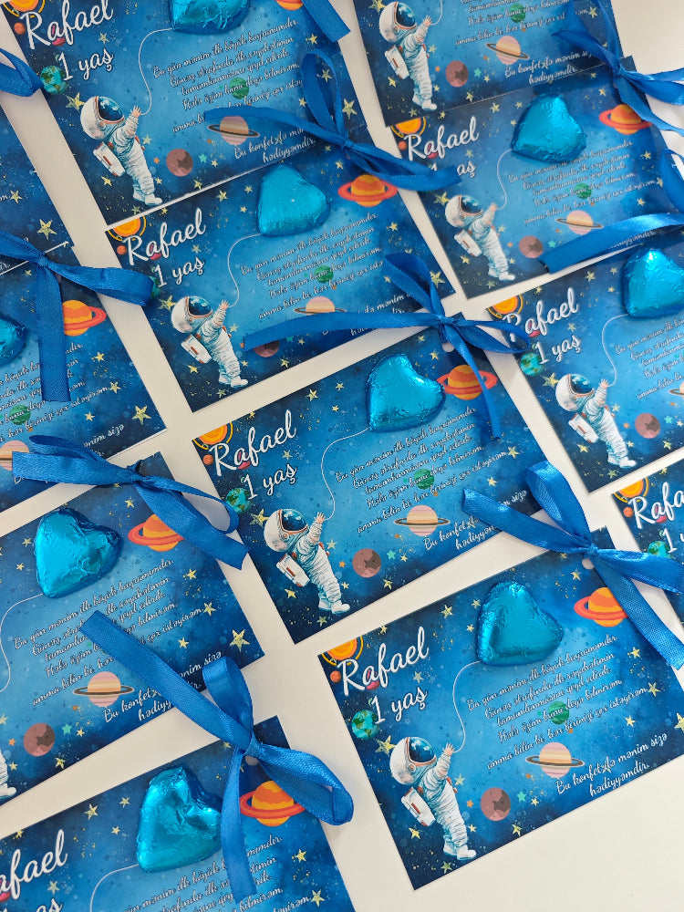 Blue gift bags with space-themed design and blue ribbons on a white background