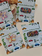 Four greeting cards with vehicle and nature-themed designs on a light background.