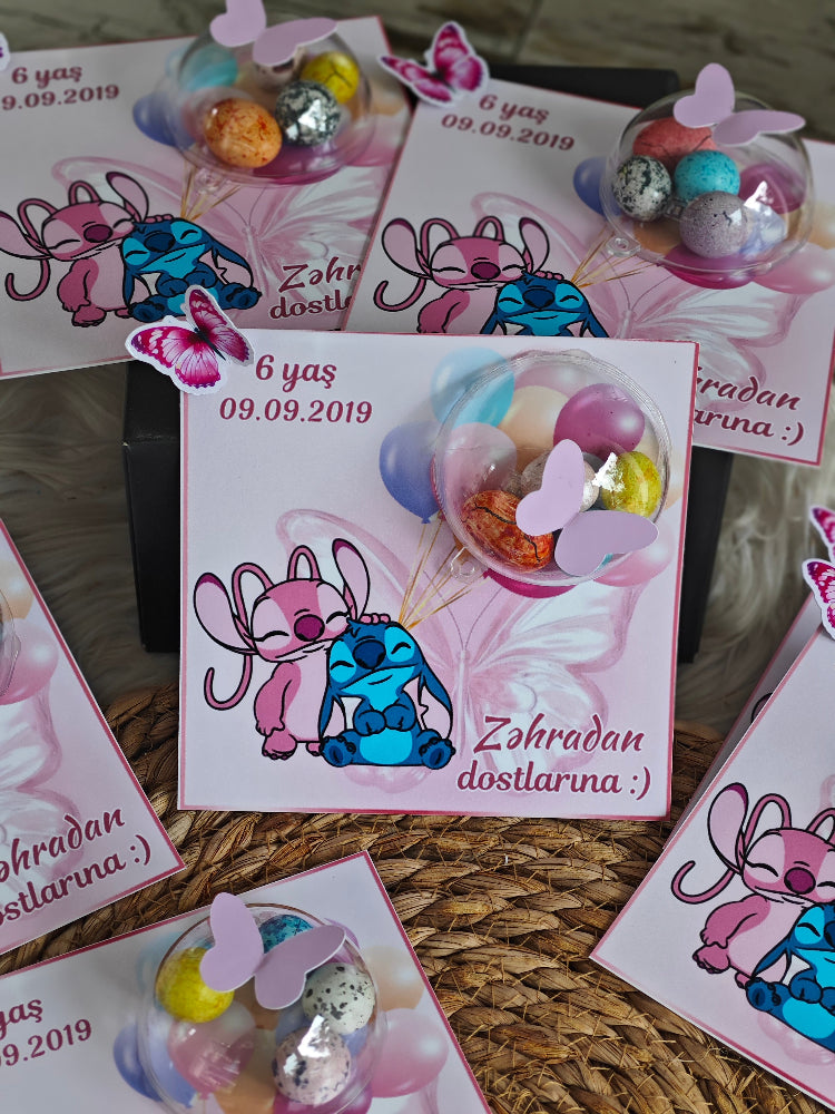 Stitch-themed cards with cartoon characters and colorful decorations on a woven surface.
