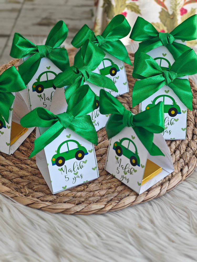 Gift tags with green ribbons on a woven mat