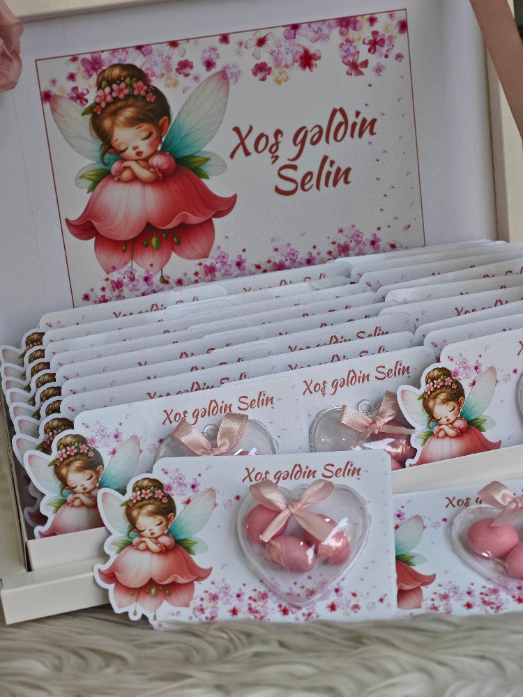 Set of cards with fairy design and text 'Xog goldin Selin' on a white surface.