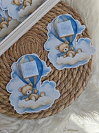 Decorative wreath with teddy bear and hot air balloon design on a textured surface.