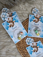 Party favor bags with teddy bear and balloon design on a textured surface