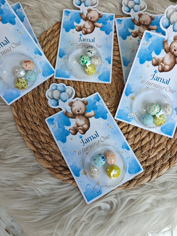 Set of personalized bear-themed cards on a textured surface