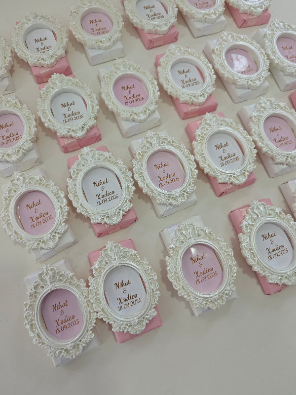 Decorative boxes with ornate lids and pink bases on a light background