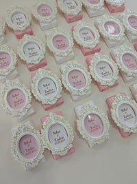 Decorative boxes with ornate lids and pink bases on a light background
