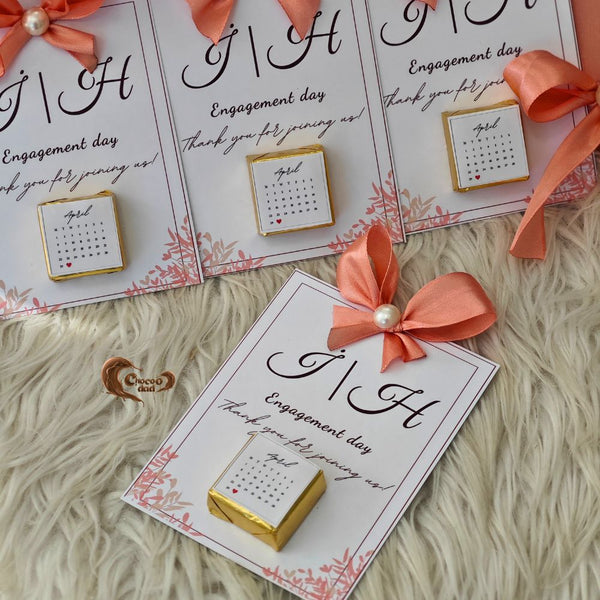 Mark your special day with beautifully designed calendar-themed chocolate cards, featuring your engagement date elegantly displayed on each piece. These unique favors are perfect for sharing your joy with loved ones