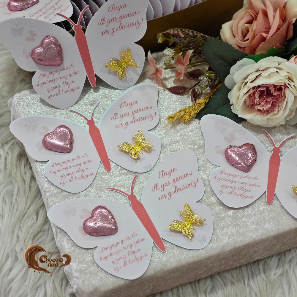 elebrate the first birthday of little Elia with these adorable pink butterfly design chocolate cards, specially created to mark this memorable milestone. These beautiful cards are the perfect combination of sweetness and elegance, symbolizing the joy Elia has brought into your lives.
