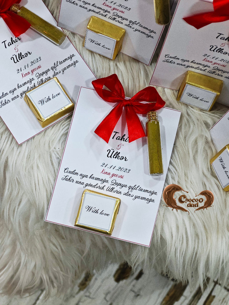 Gift boxes with red ribbons and gold accents on a textured surface
