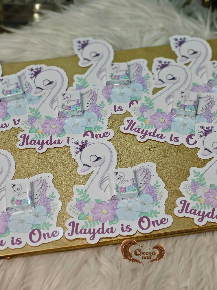 Sticker sheet with swan design and text 'Ilayda is One' on a gold card.